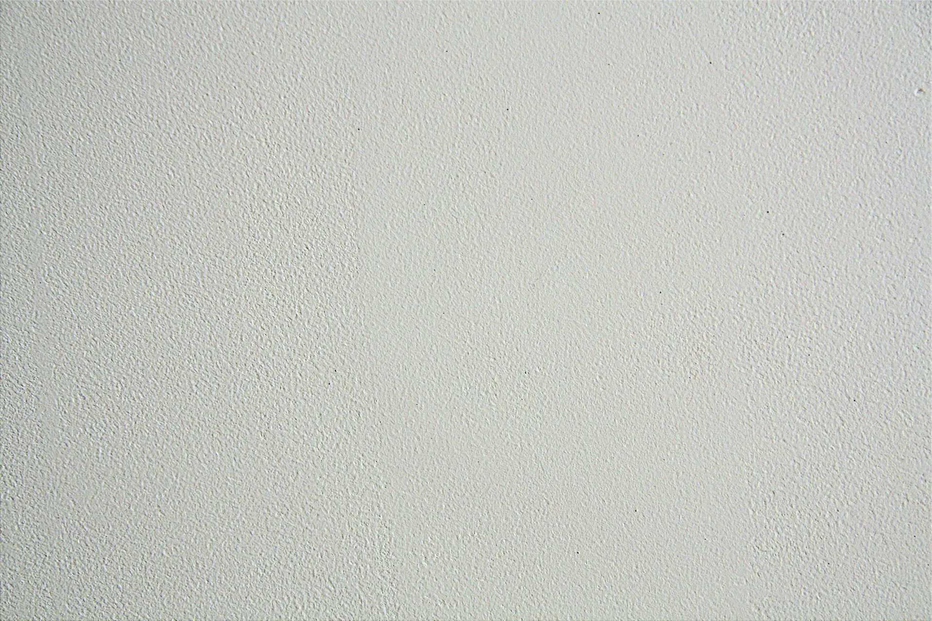 Close-up of a textured white wall, ideal for backgrounds in design projects.